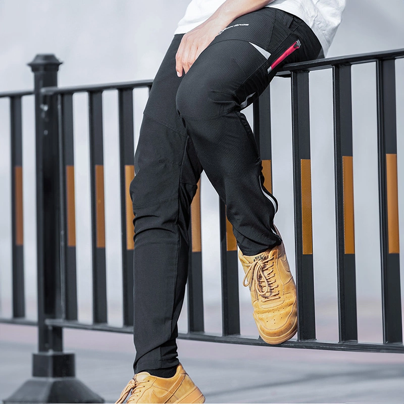 Persona con pantaloni neri e scarpe gialle seduta su una ringhiera.