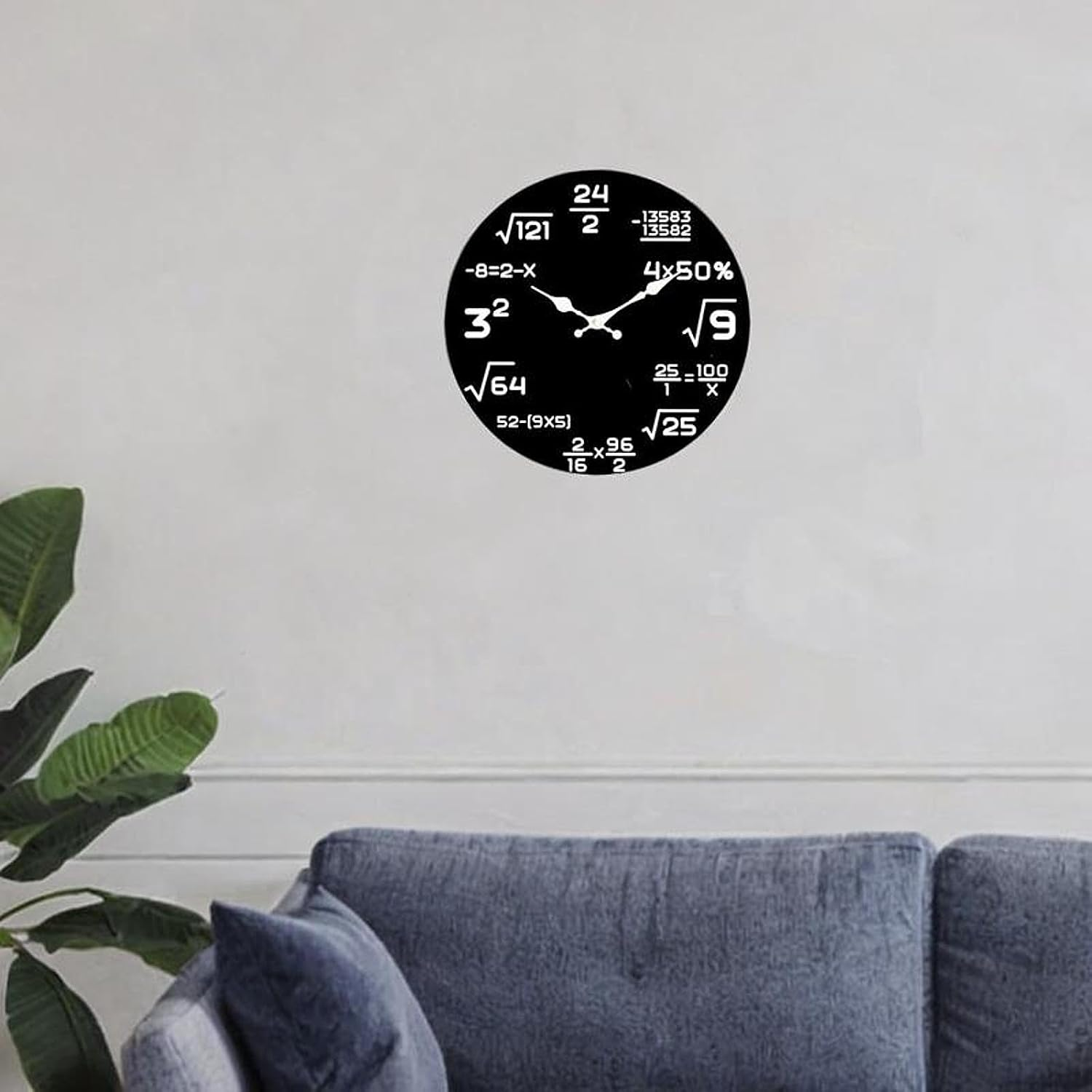 Eine schwarze Wanduhr mit mathematischen Formeln anstelle von Zahlen hängt an einer weißen Wand über einer Couch.