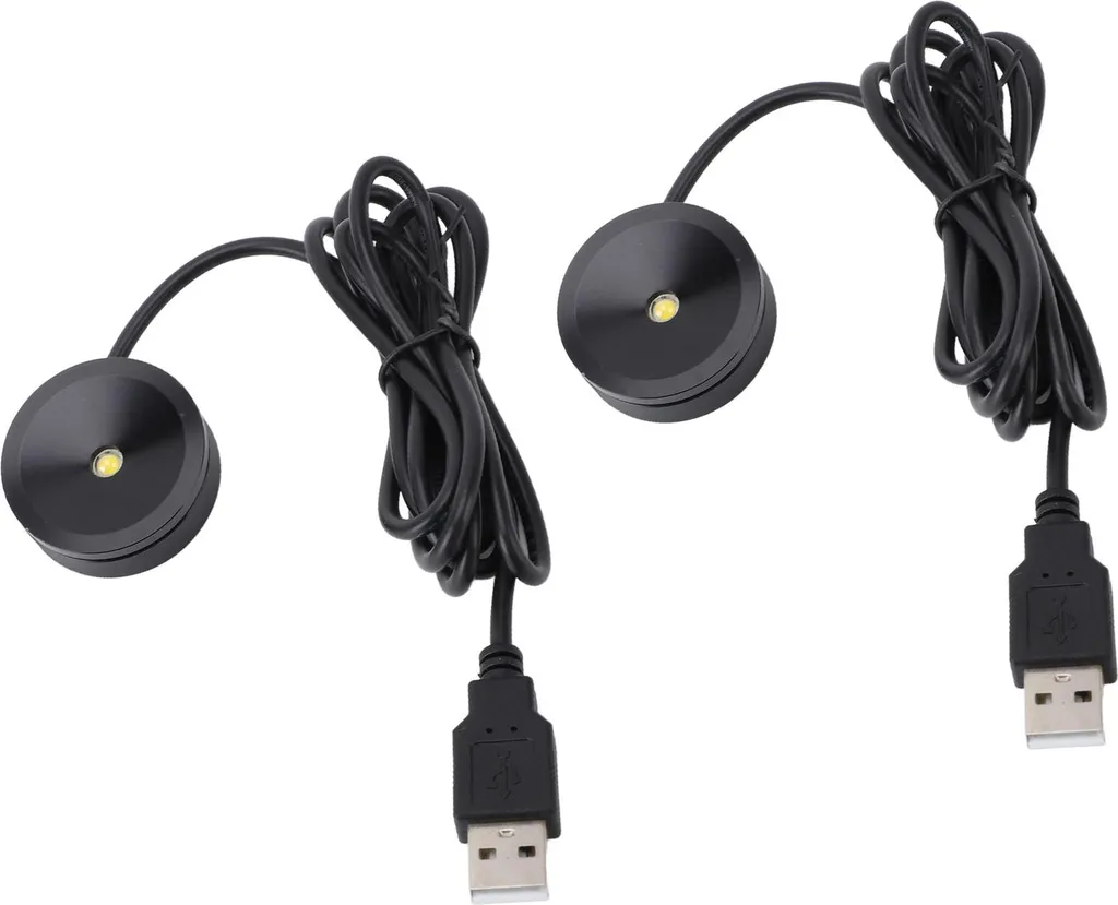 Zwei kleine runde schwarze LED-Lampen mit langen Kabeln und USB-Anschlüssen auf weißem Hintergrund.