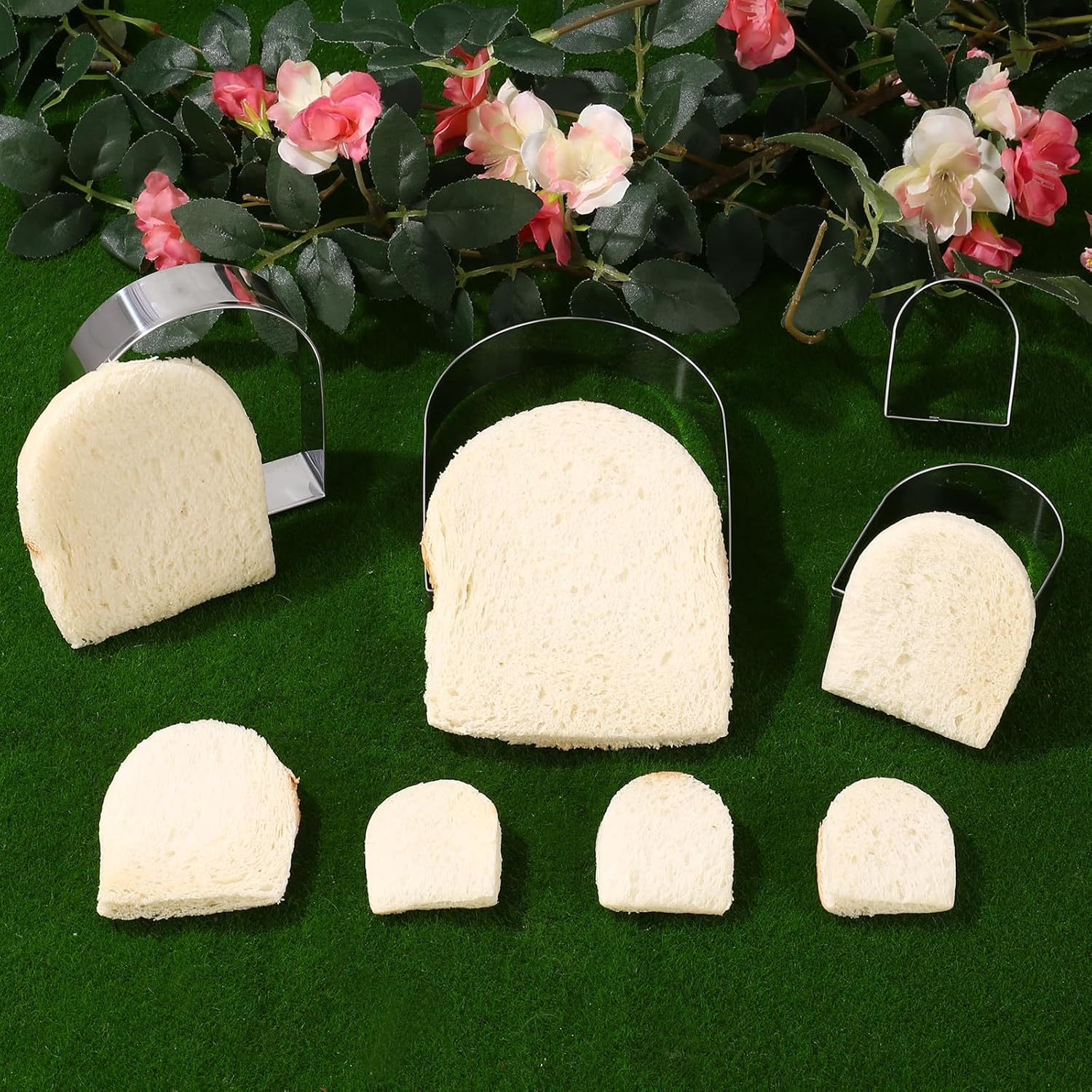 Brotstücke in verschiedenen Größen und Metallformen auf grünem Hintergrund mit Blumen.