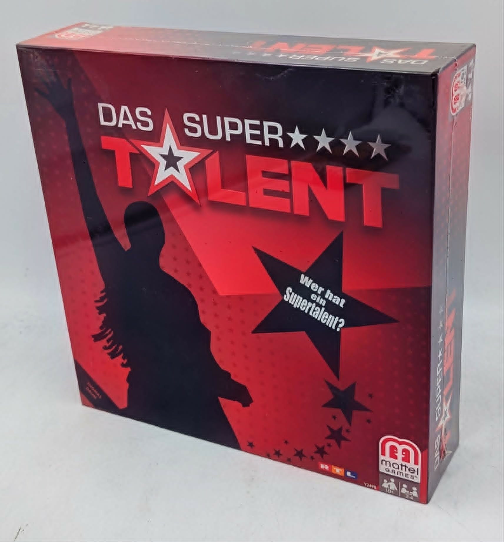 Spielschachtel Das Supertalent in Rot und Schwarz mit Sternen und der Silhouette einer Person mit erhobener Hand.