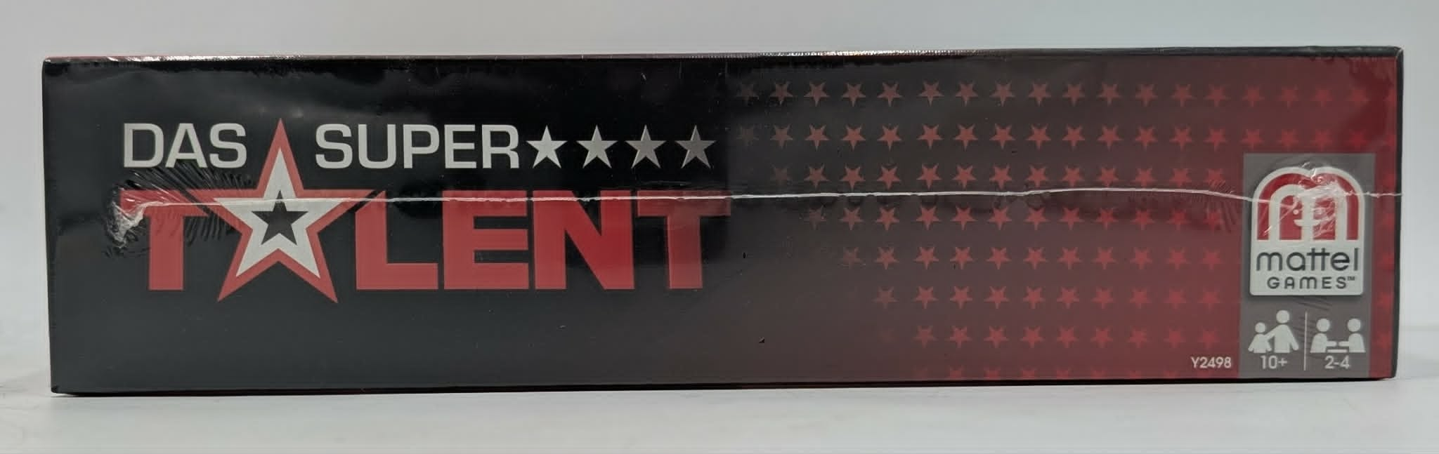 Seitenansicht der Das Super Talent Mattel Brettspielschachtel mit Sternenmuster und rotem Logo auf schwarzem Grund.