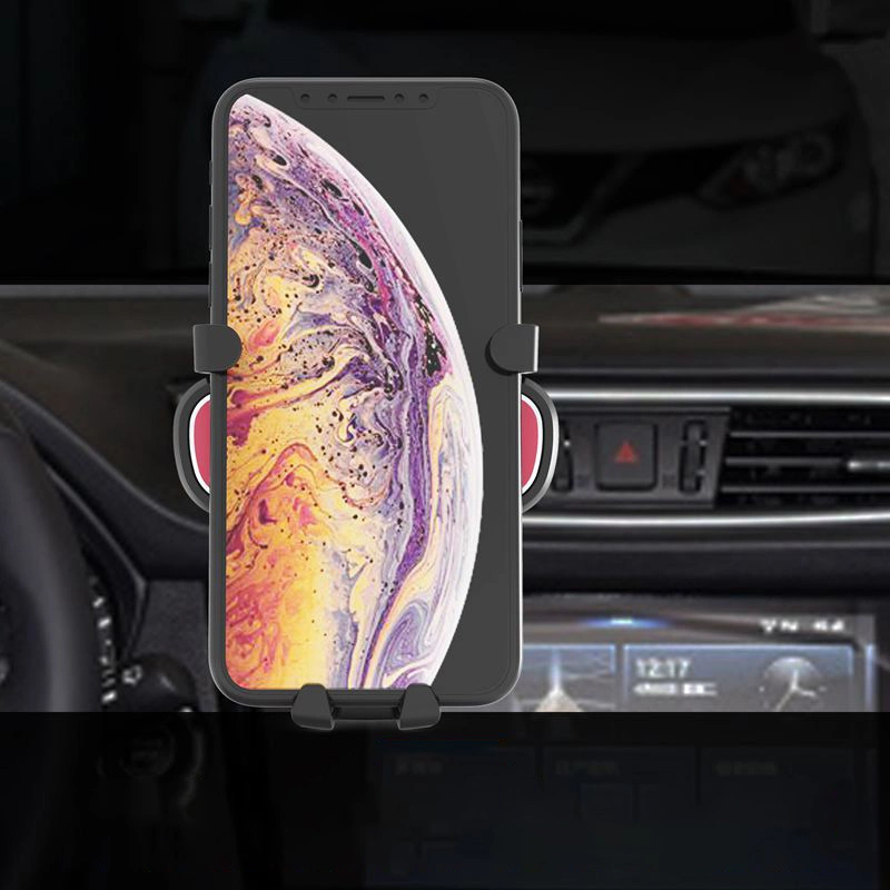 Un supporto per telefono da auto nero con uno smartphone dallo schermo colorato è montato sul cruscotto.