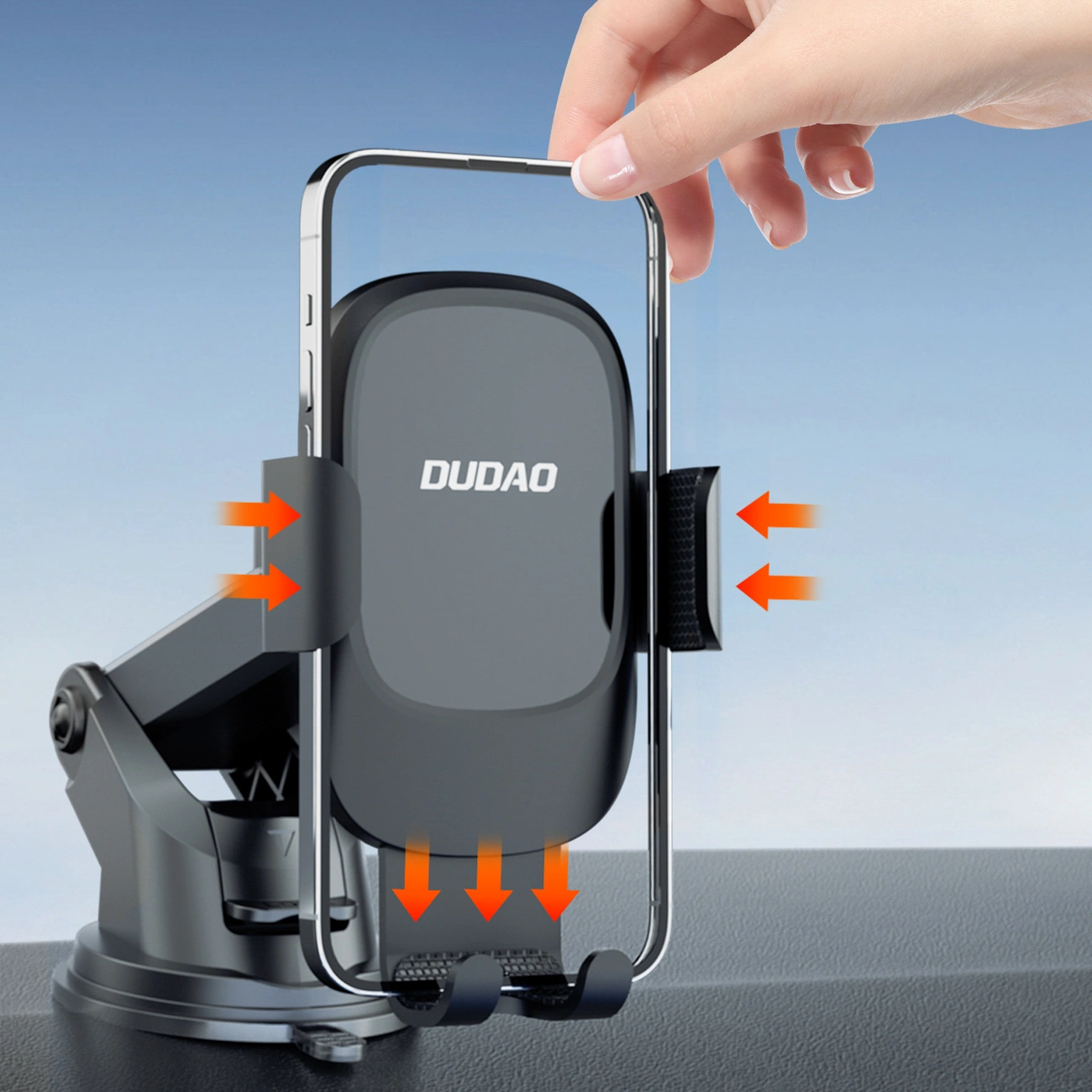 Supporto per telefono con ventosa su superficie scura, una mano tiene una cornice per smartphone vuota.