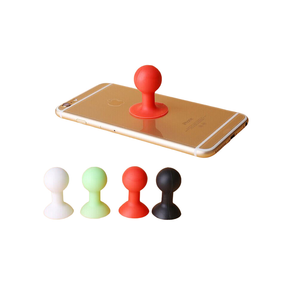 Uno smartphone dorato con un supporto a ventosa rosso attaccato. Sotto ci sono altre quattro ventose colorate.