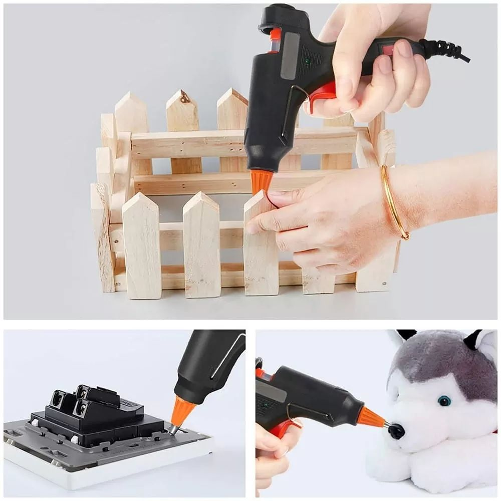 Eine Heißklebepistole wird zum Basteln an einer Holzkiste, einem elektrischen Bauteil und einem Stoffhund verwendet.