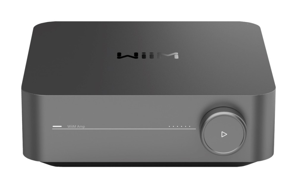 Szary odtwarzacz audio WiiM Amp z zaokrąglonymi rogami, pokrętłem głośności i eleganckim designem na białym tle.
