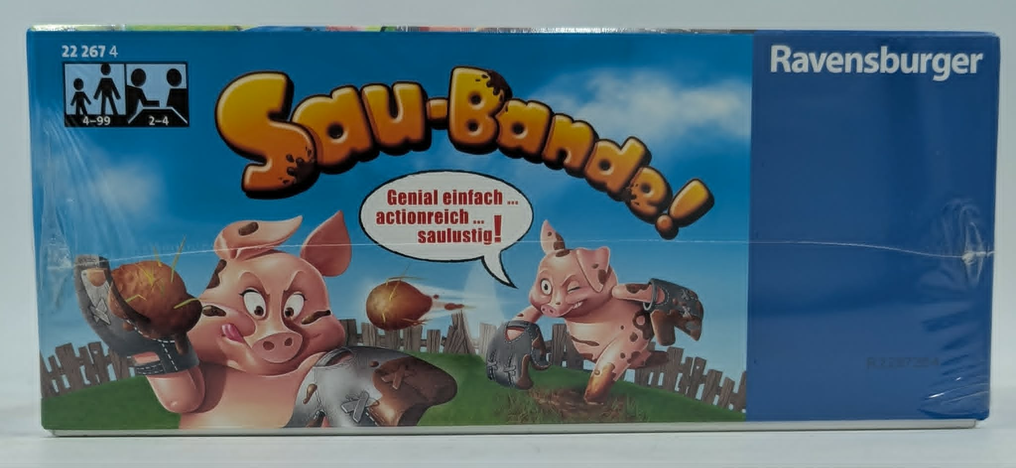 Ravensburger Sau-Bande Brettspielschachtel mit schlammbedeckten Zeichentrickschweinen und blauem Himmel.