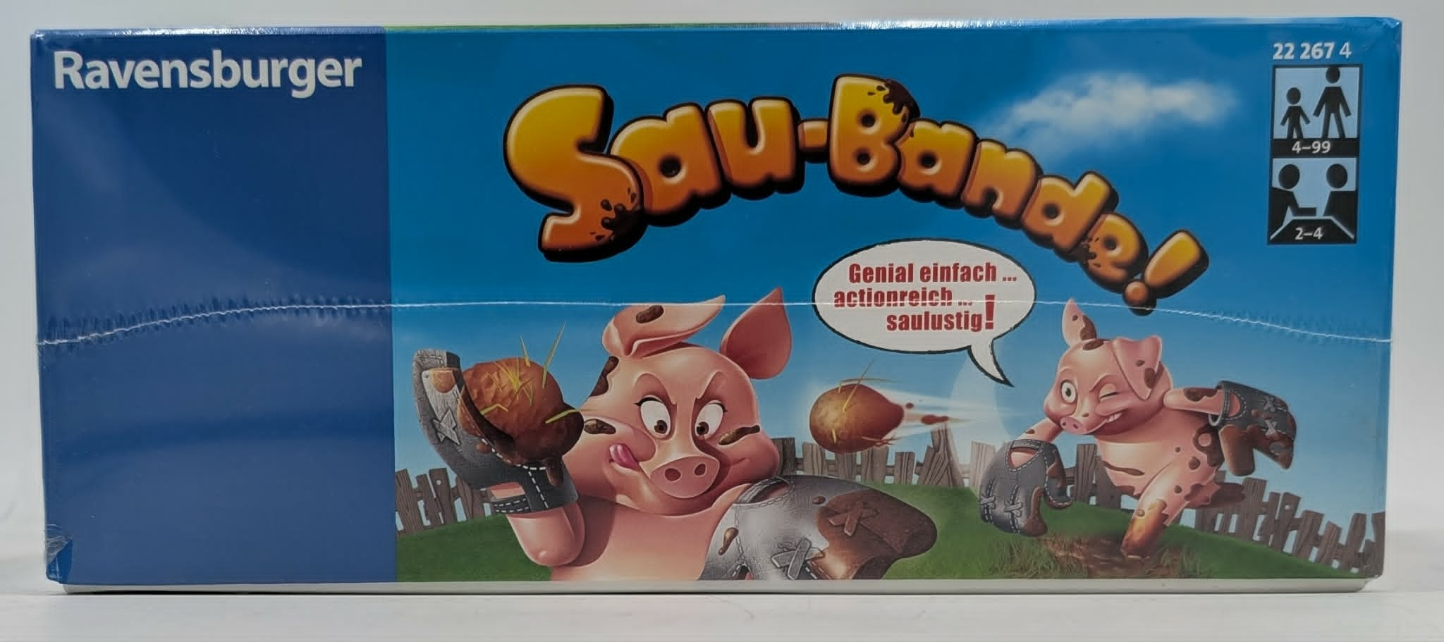 Ravensburger Brettspielverpackung Sau-Bande! mit zwei cartoonartigen Schweinen, die im Schlamm spielen.