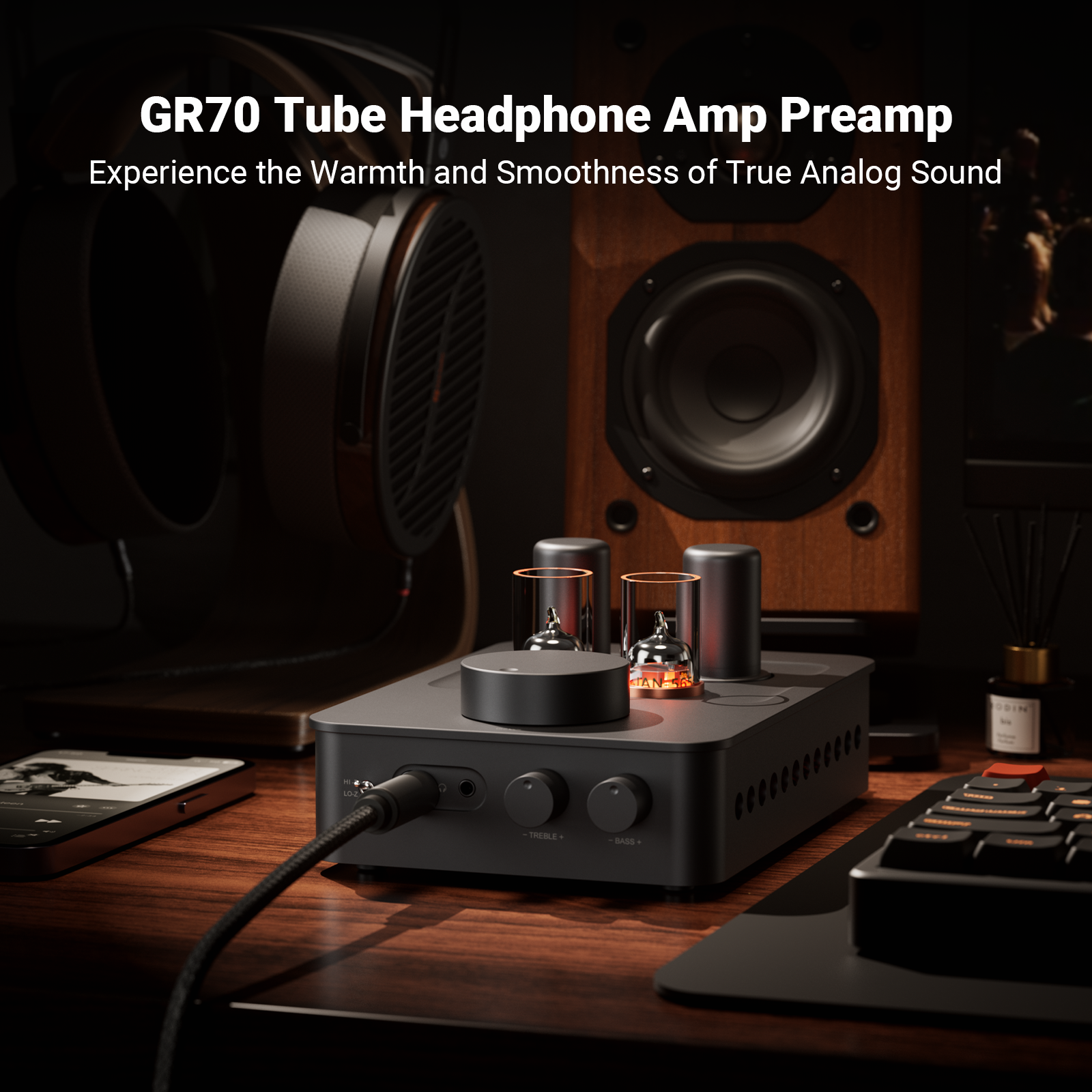 Tube headphone amp on a wooden desk with headphones and speakers in the background.