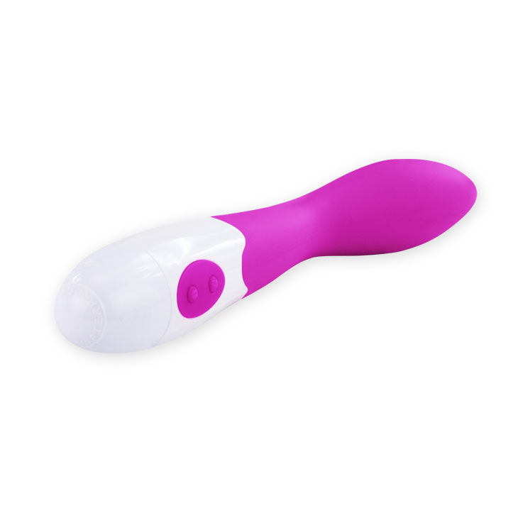 Un vibrador de masaje blanco y rosa sobre un fondo blanco.