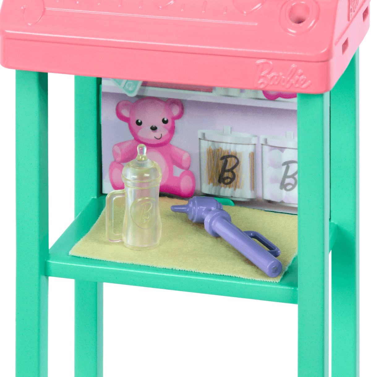 Un supporto Barbie rosa e verde acqua con biberon e otoscopio.