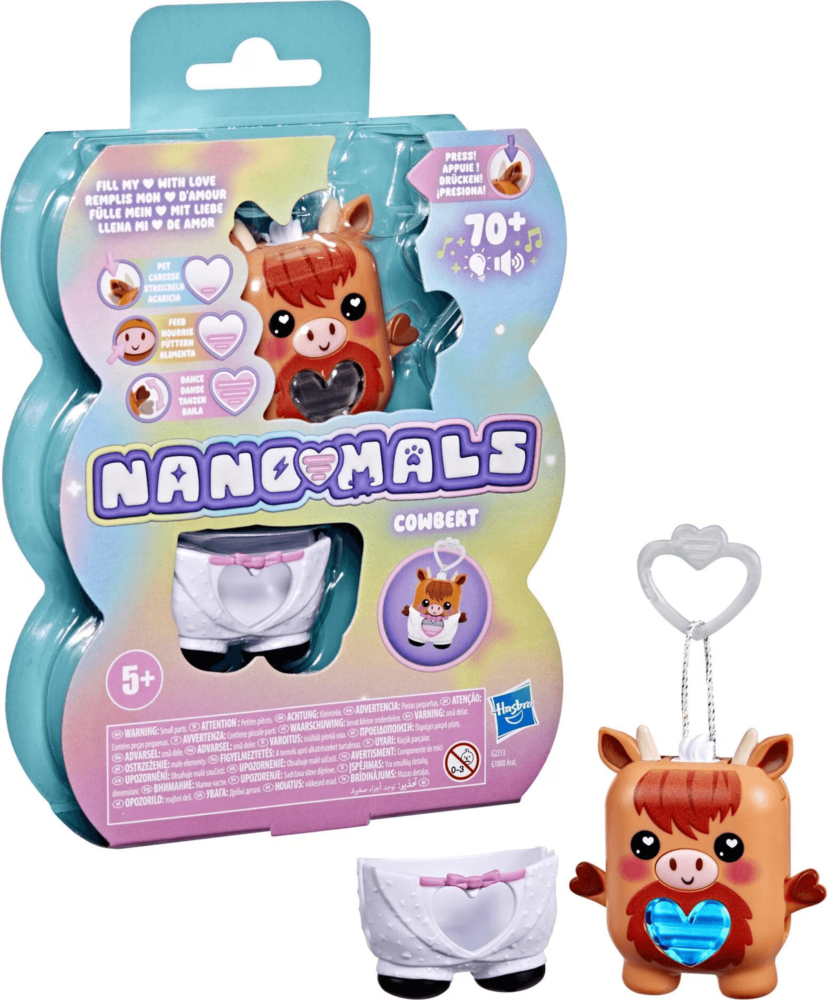 Juguete Nanomals Cowbert en su empaque junto a la figura de vaca marrón desempacada con un pañal blanco y un llavero.