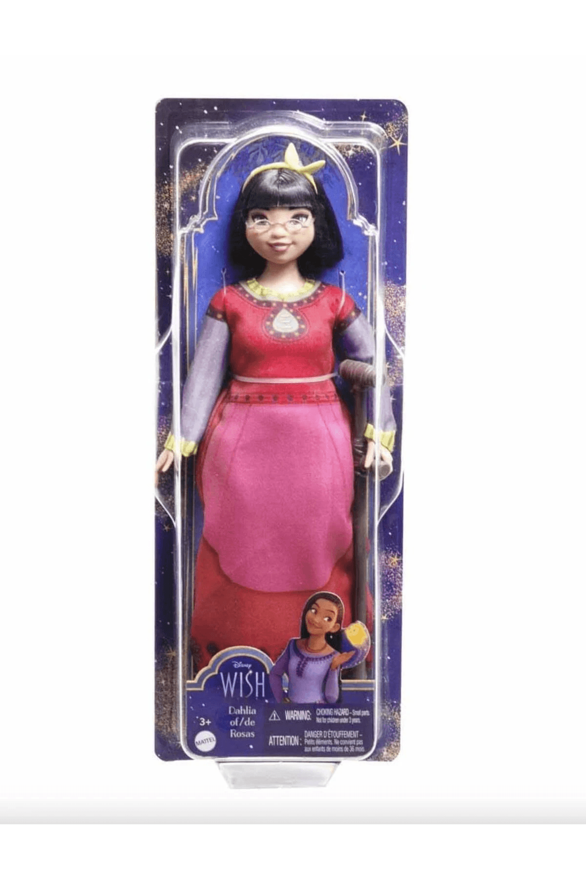 Eine Disney Wish Dahlia Puppe in Verpackung, mit einem rot-rosa Kleid, Brille und Gehstock.