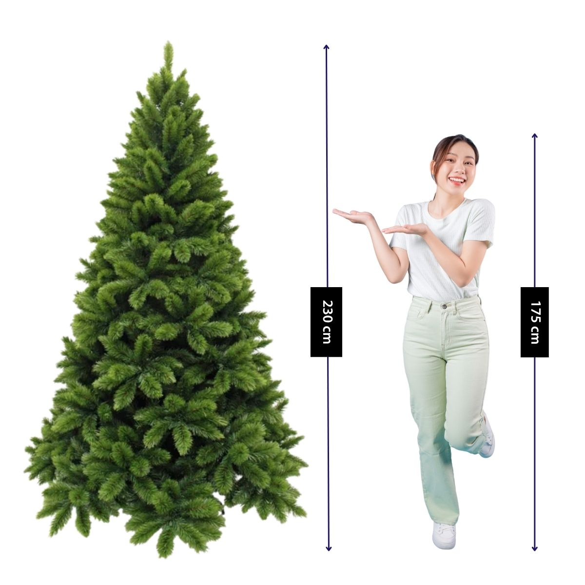 A woman in green clothing poses next to a 230 cm Christmas tree against a white background.