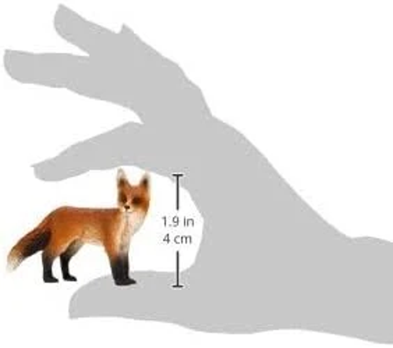 Una piccola statuetta di volpe confrontata con una mano, alta 1,9 in o 4 cm.