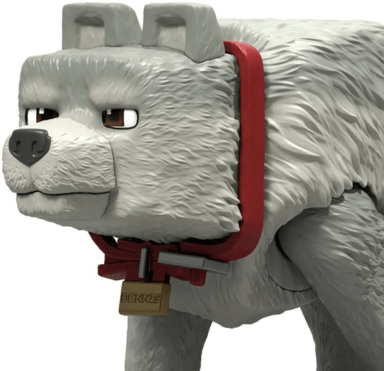 Primer plano de un lobo de juguete gris y cuadrado con collar rojo y una placa con nombre.