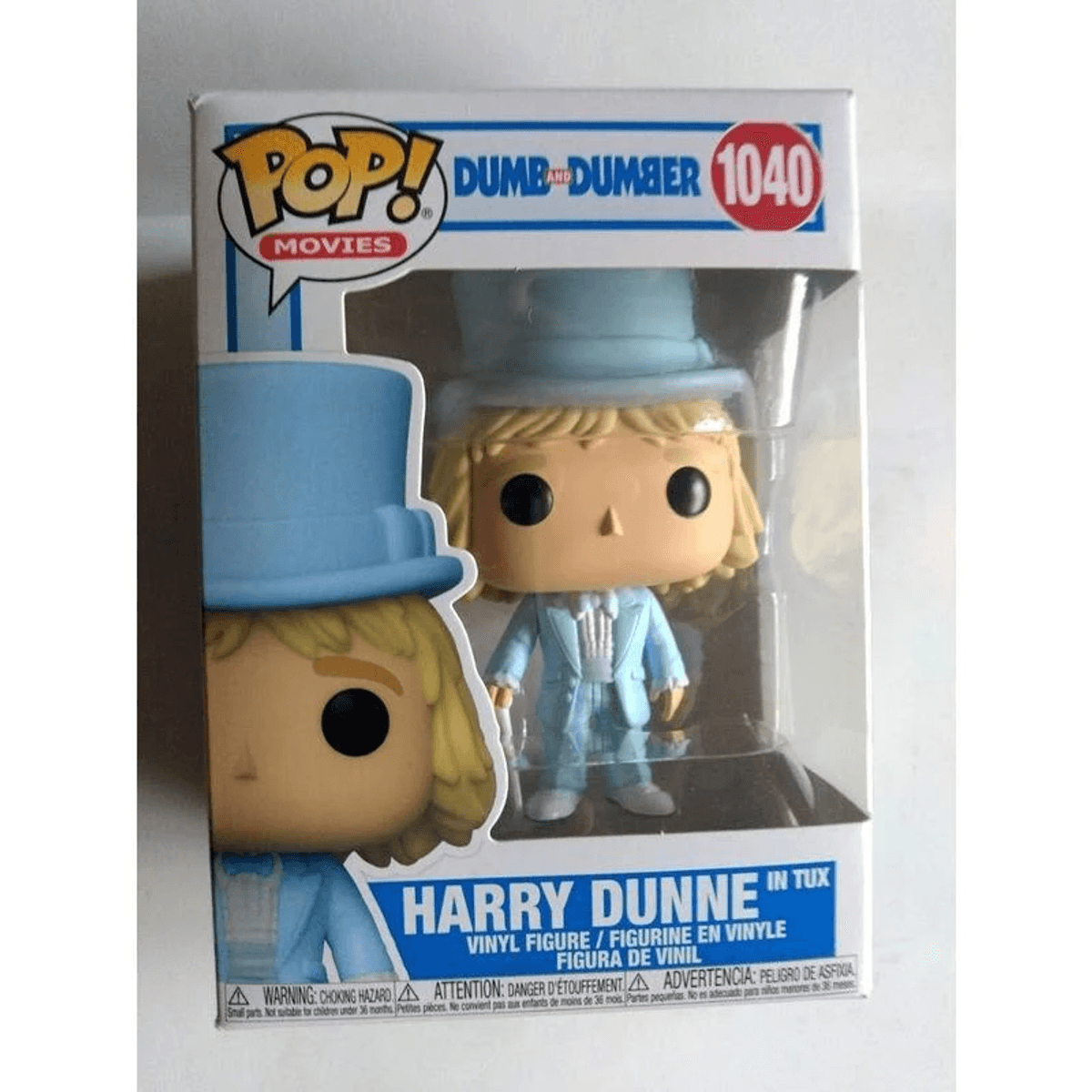 Figura Funko Pop di Harry Dunne in smoking azzurro e cilindro nella sua scatola.