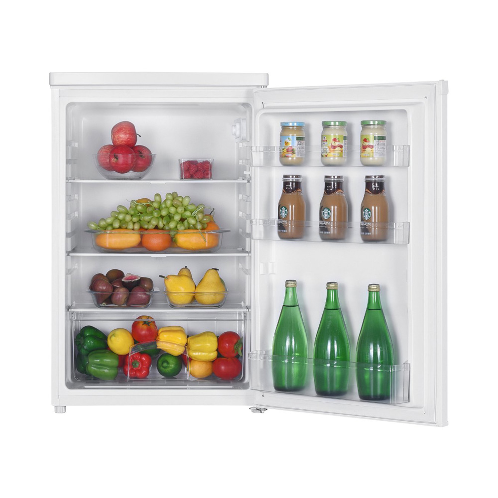 An open white mini fridge is fully stocked with fresh fruit, bottles, and jars on its shelves.