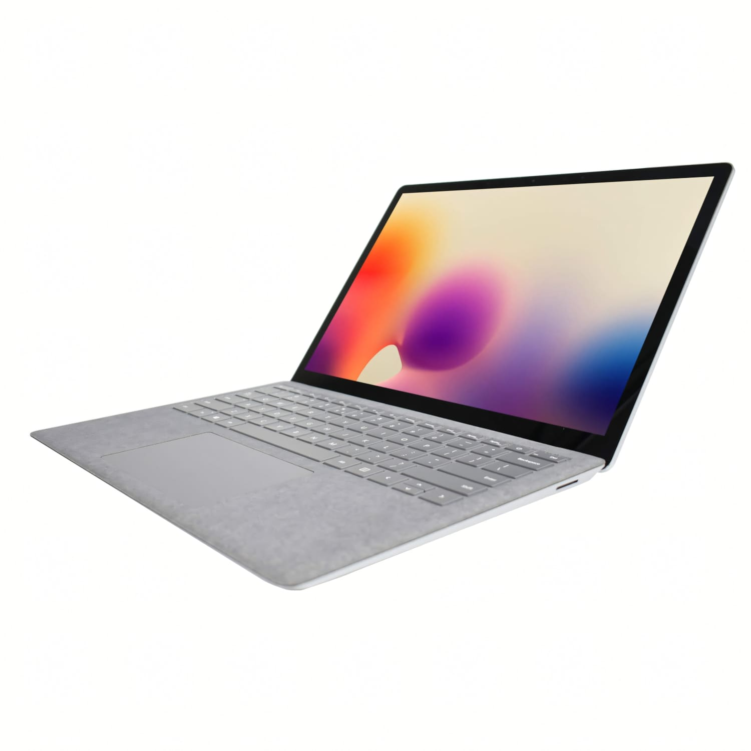Un ordenador portátil plateado con teclado de tela y pantalla colorida sobre fondo blanco.