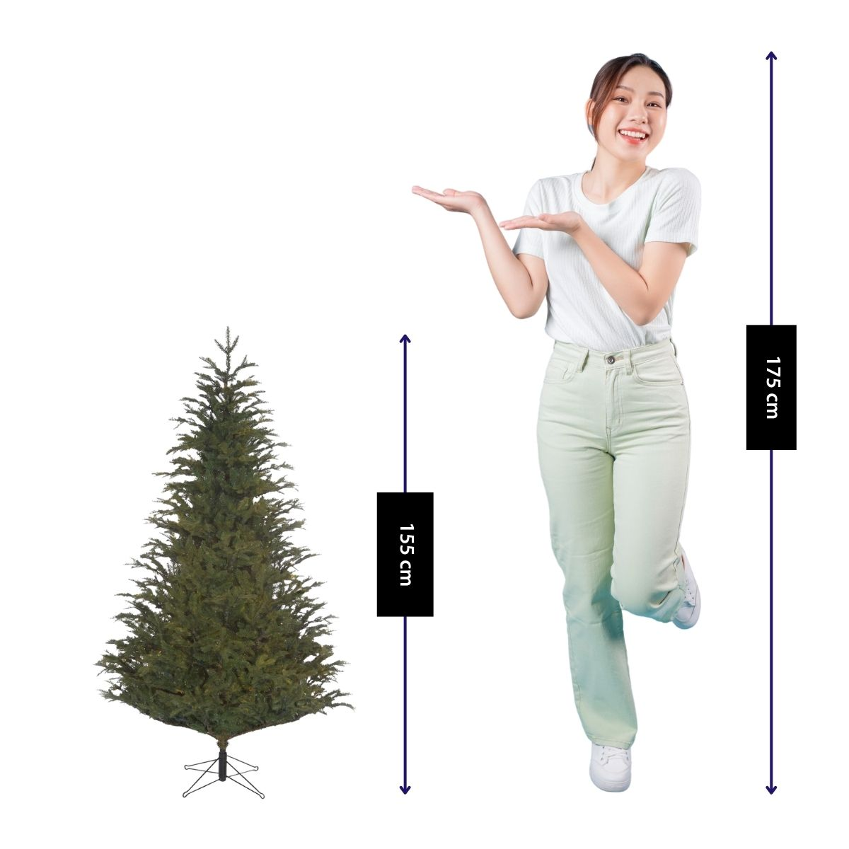 A woman in green pants presents a 155 cm Christmas tree next to height measurement arrows.
