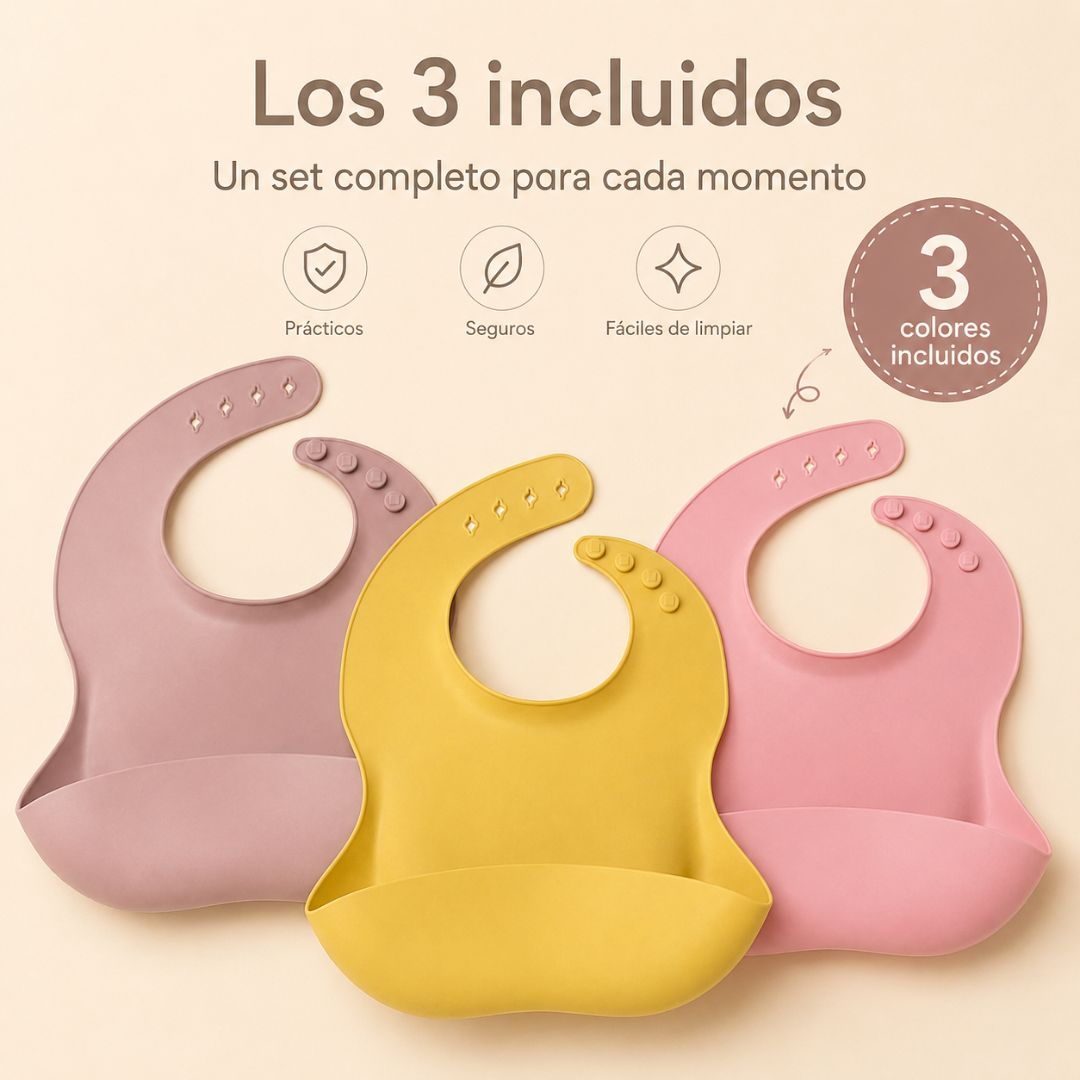 Tres baberos de silicona de colores con recogemigas se muestran sobre un fondo claro.