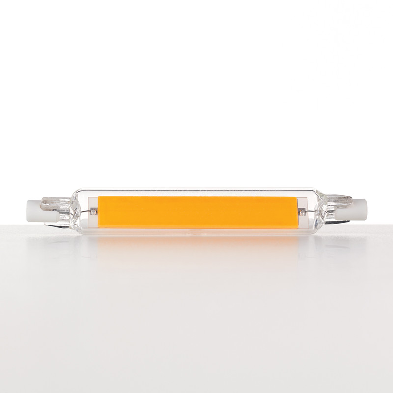 Eine lineare LED-Lampe mit einem länglichen gelben Leuchtstreifen in einer Glasröhre auf einer weißen Oberfläche.