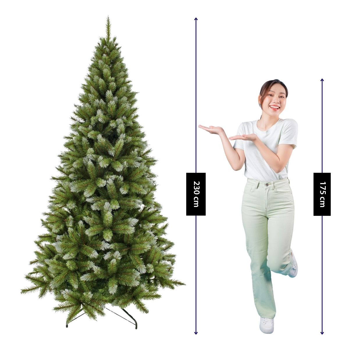 A woman gestures toward a 230 cm artificial Christmas tree, standing next to a height scale showing 175 cm.