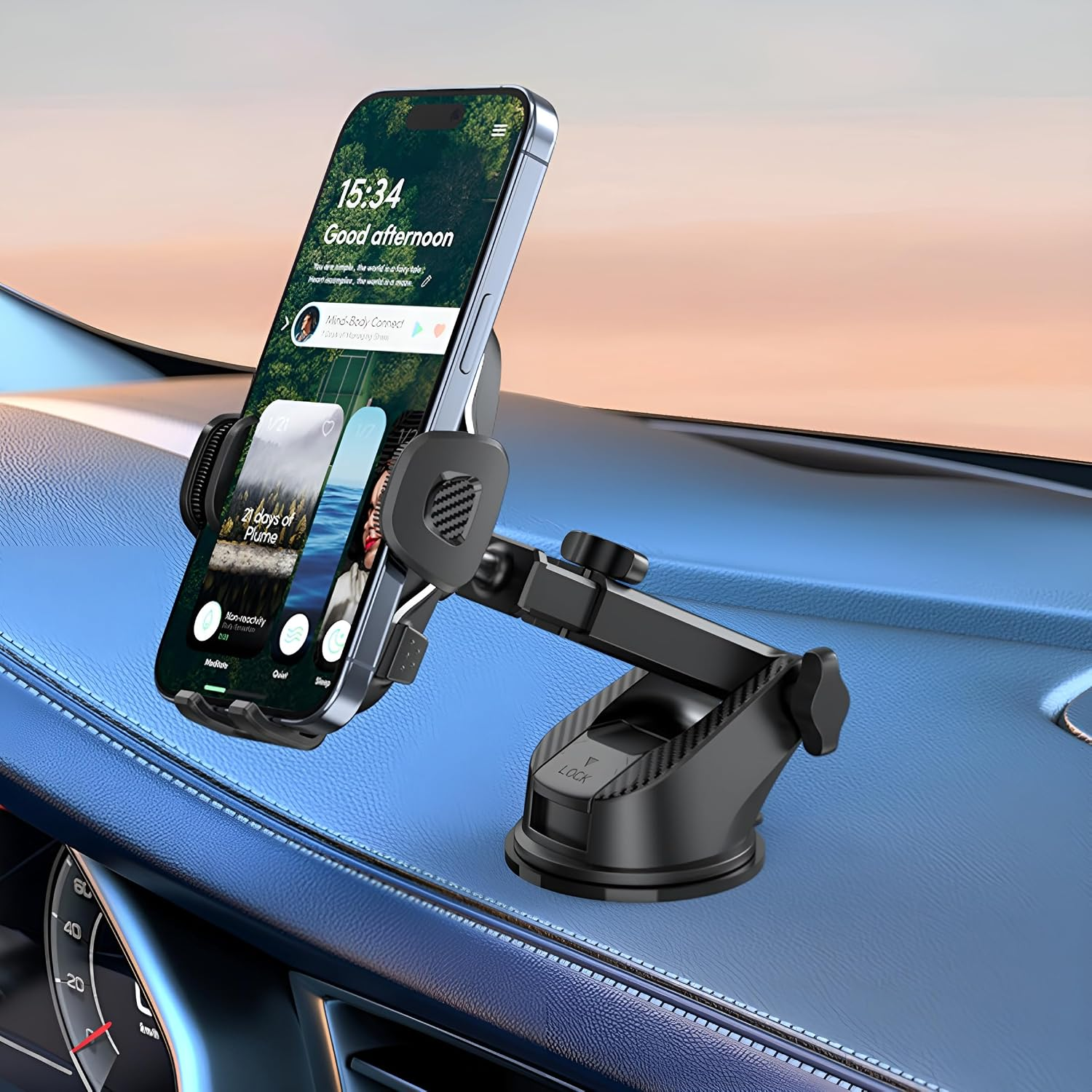 Ein Smartphone in einer schwarzen Autohalterung auf einem blauen Amaturenbrett mit Blick auf den Himmel.