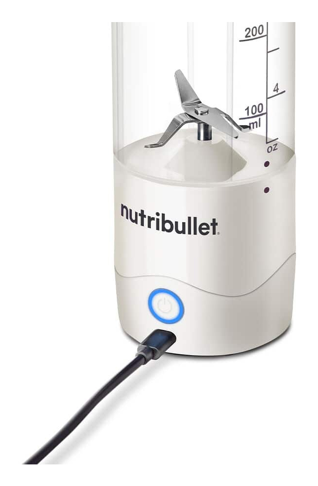 A white Nutribullet portable blender charging with a black USB cable on a white background.