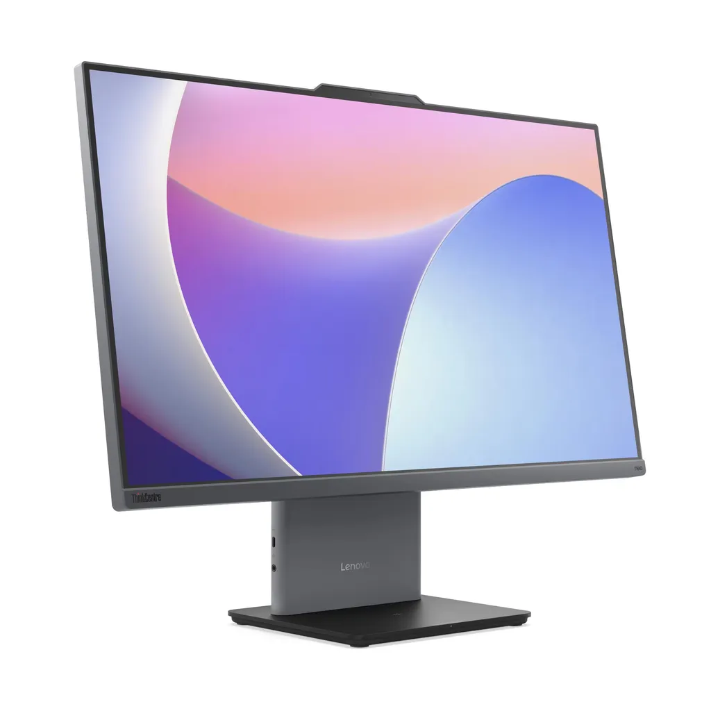 Beyaz arka planda renkli soyut duvar kağıdına sahip gri bir Lenovo hepsi bir arada bilgisayar.