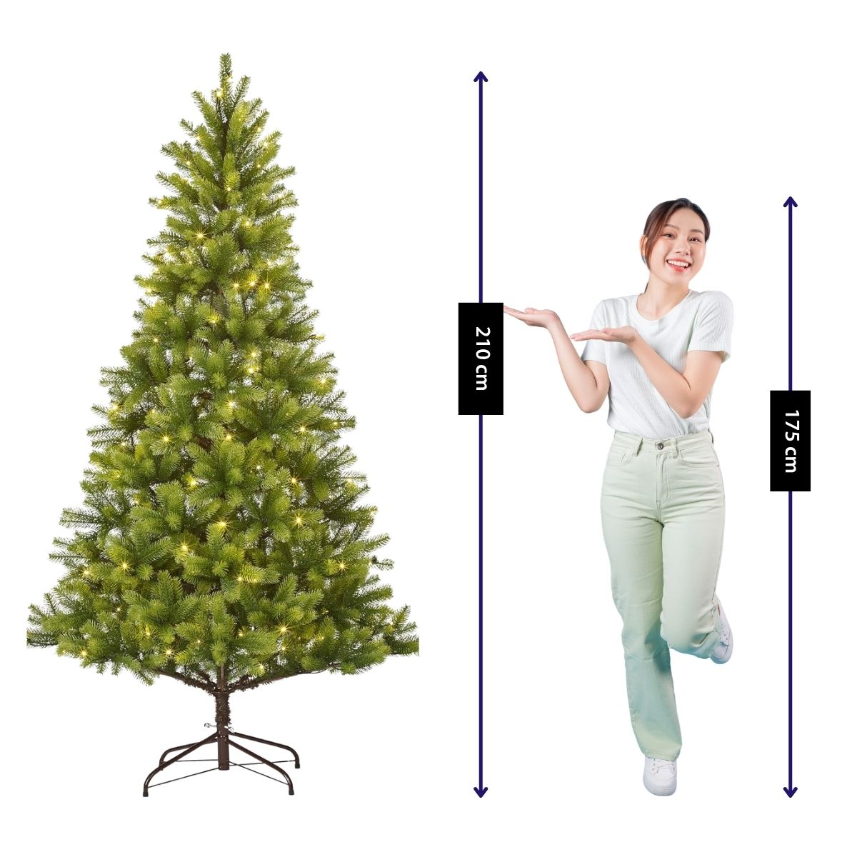 A woman poses next to a 210 cm tall Christmas tree with lights.