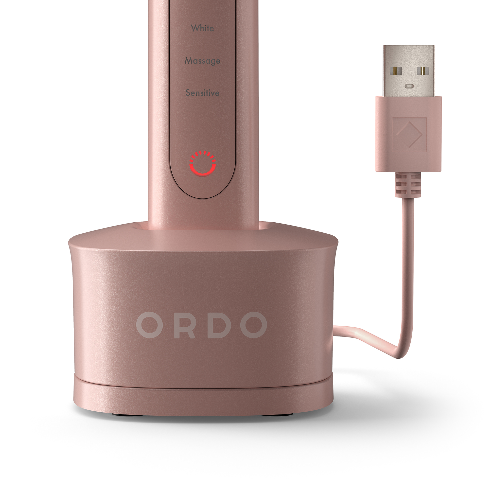 Uno spazzolino elettrico rosa Ordo nella sua base di ricarica, con cavo USB collegato su sfondo bianco.