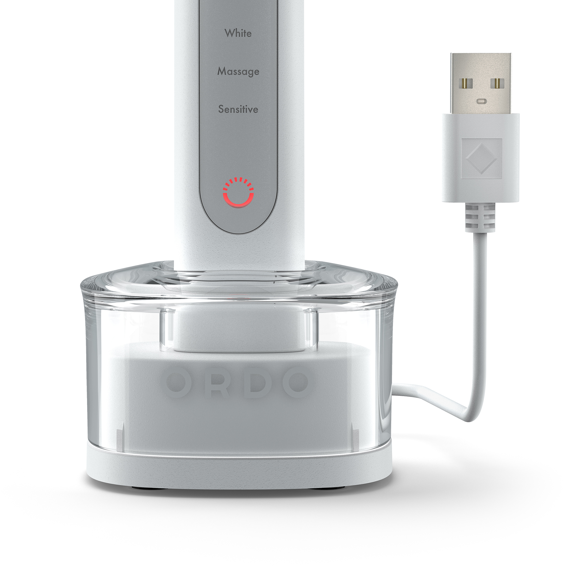 Un mango de cepillo de dientes eléctrico blanco en una base de carga transparente con cable USB.