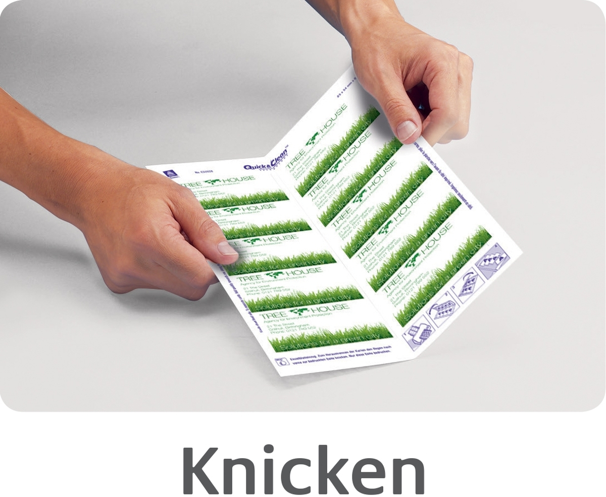 Hände knicken ein bedrucktes Papierblatt mit grünen Grafiken.
