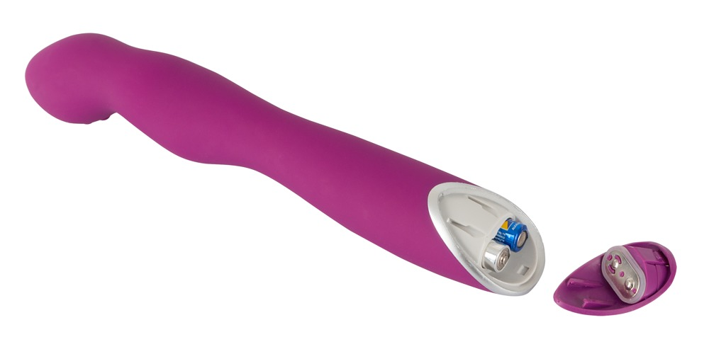 Ein rosafarbener Vibrator mit offener Batteriekammer und sichtbaren Batterien vor weißem Hintergrund.