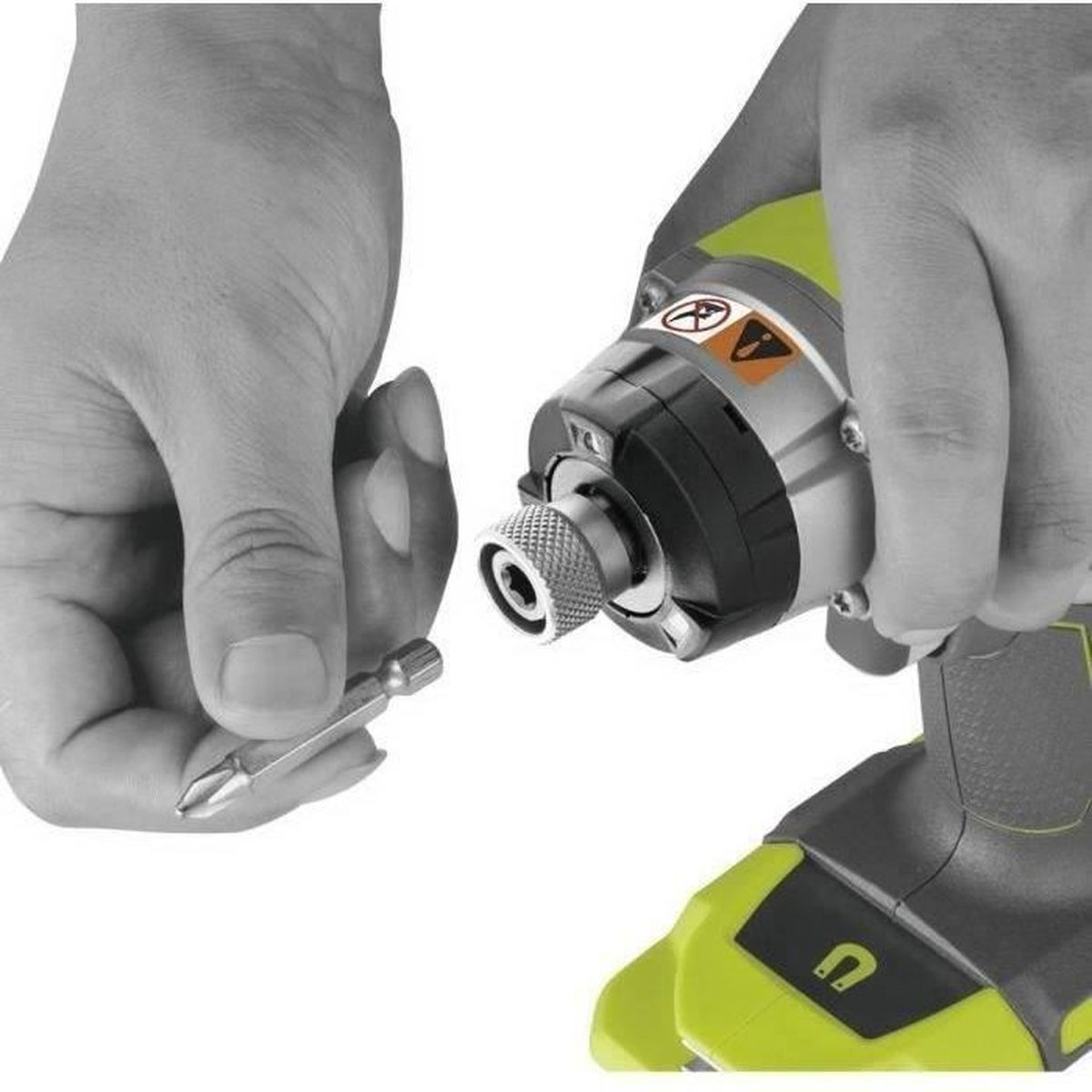 Le mani inseriscono un inserto per cacciavite nel mandrino di un trapano elettrico.