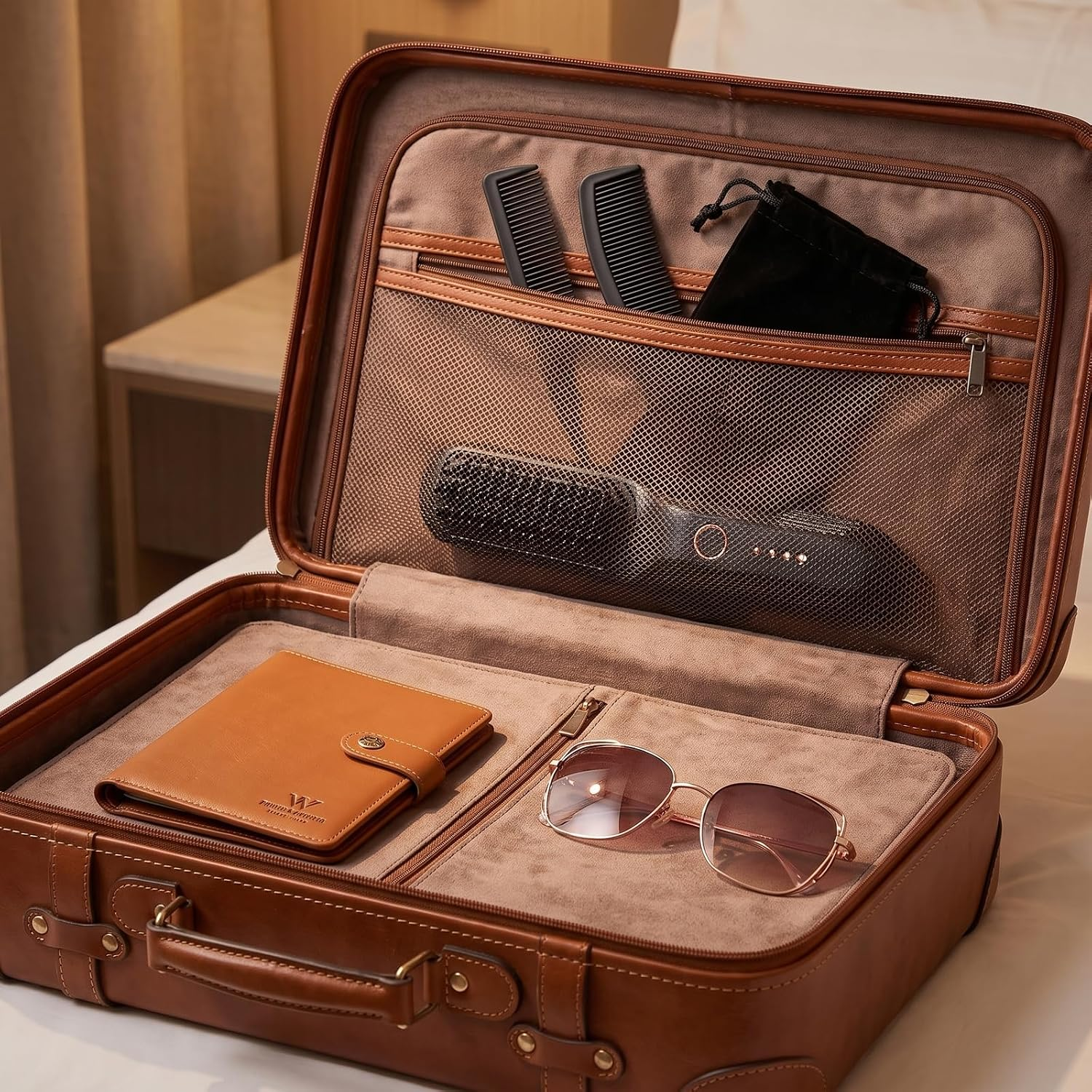 Ein offener brauner Lederkoffer mit Brieftasche, Sonnenbrille, Kämmen und einer Haarbürste im Inneren.