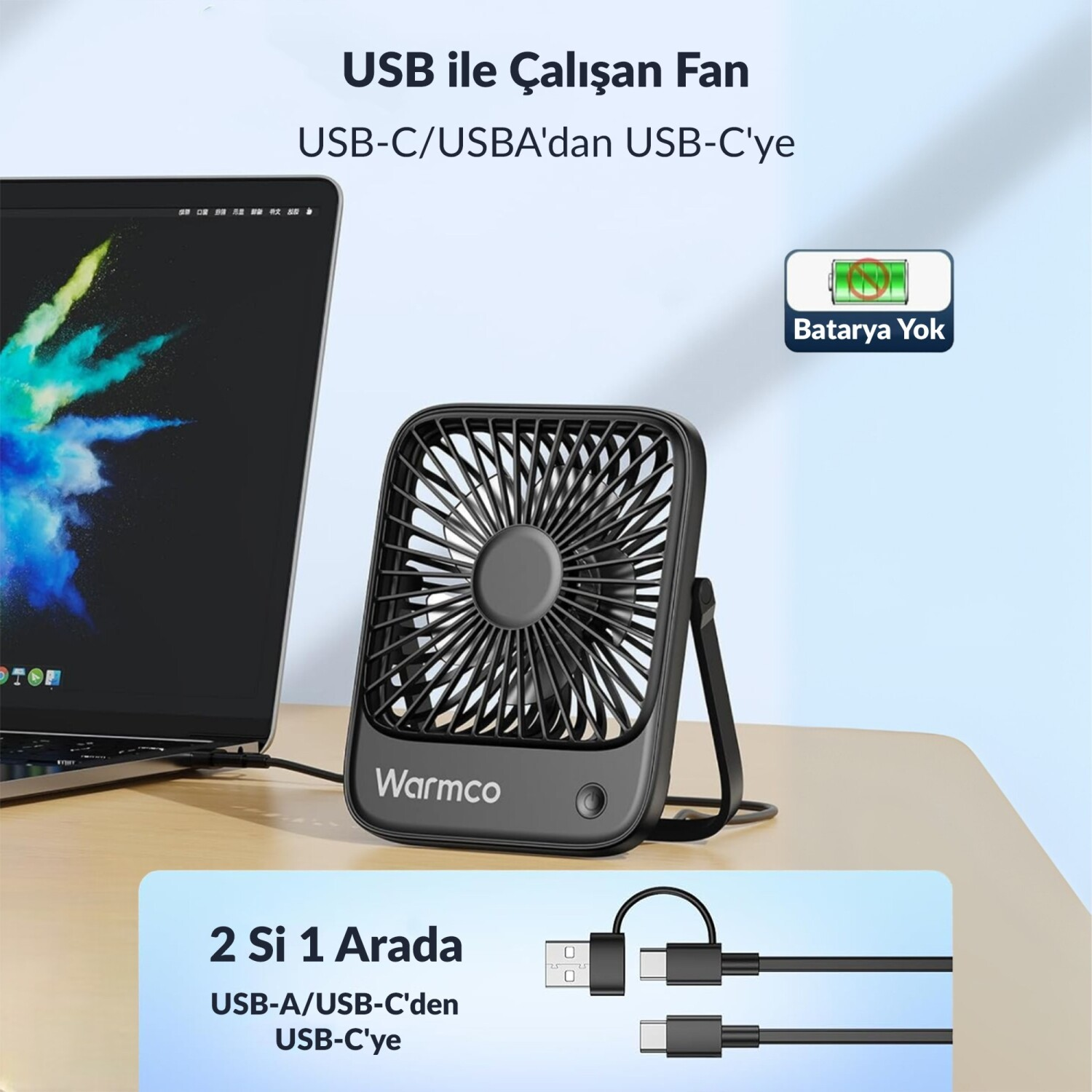Masaüstünde dizüstü bilgisayar yanında siyah USB fan.