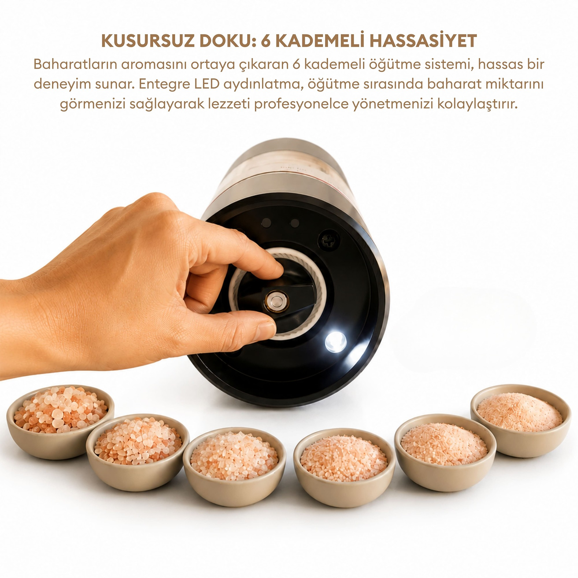 Bir el, altındaki altı pembe tuz kasesiyle siyah baharat öğütücüsünün ayarını yapıyor.