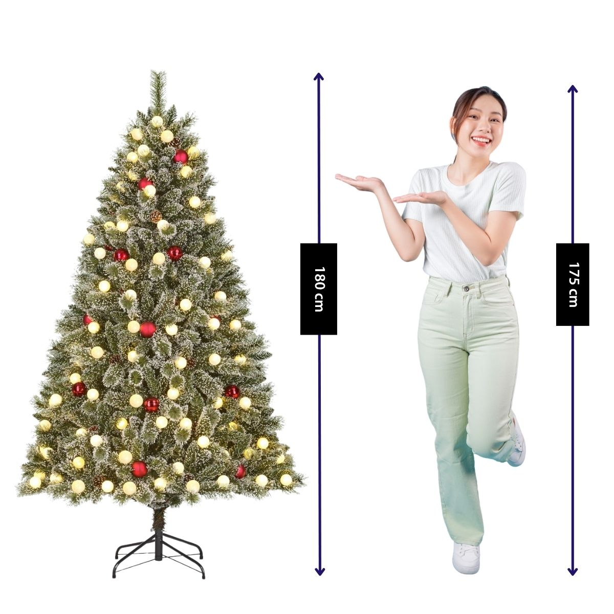Een vrouw in lichte kleding staat naast een versierde kerstboom van 180 cm.