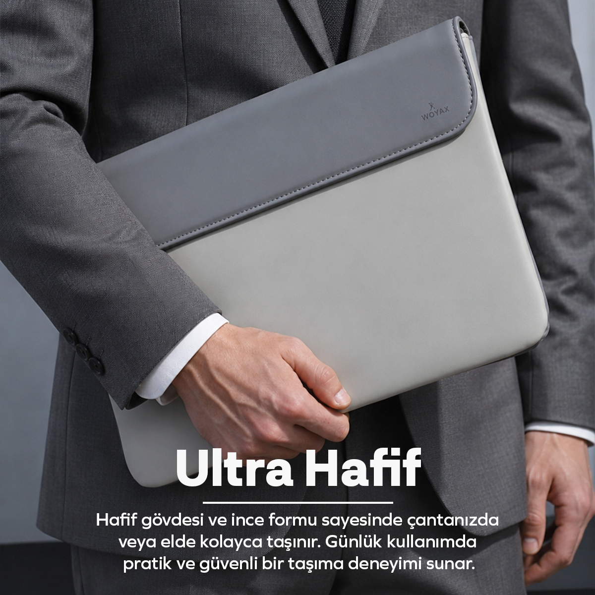Gri takım elbiseli bir iş adamı koyu gri kapaklı açık gri bir laptop kılıfı tutuyor. Altta Türkçe yazı var.