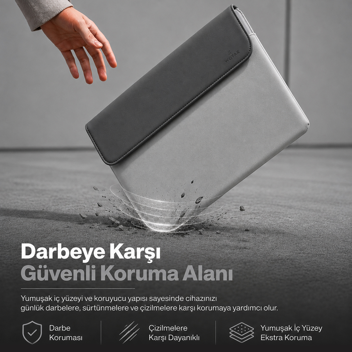 Gri renkli bir laptop kılıfı yere düşüyor; darbe emici grafikler, metin ve simgeler yer alıyor.