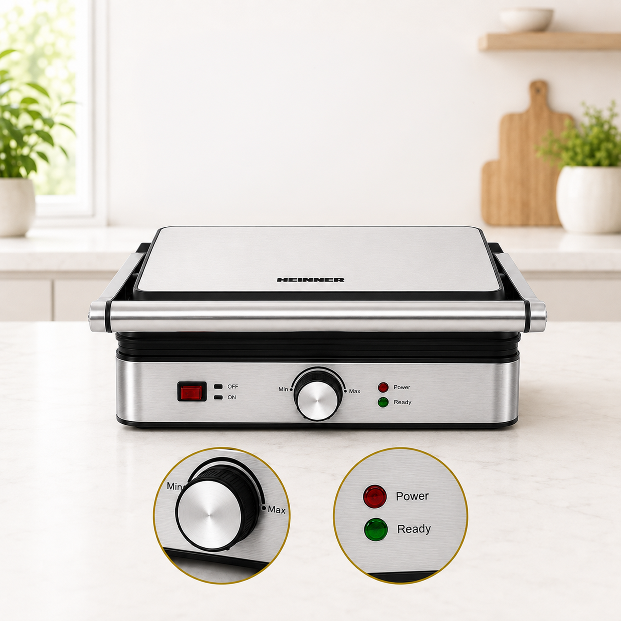 Un gril de contact en acier inoxydable sur un comptoir de cuisine, avec un bouton et des voyants.