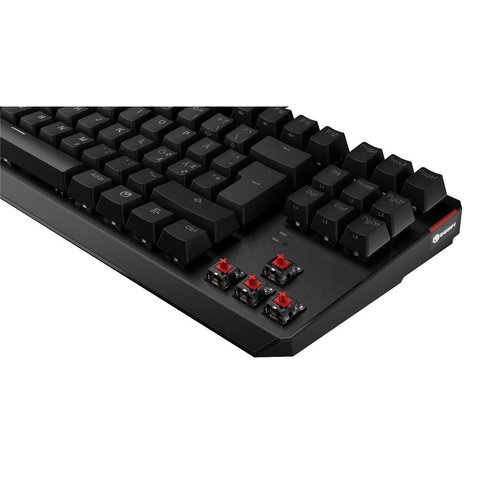 Schwarze mechanische Tastatur mit sichtbaren roten Switches ohne Keycaps in der Ecke.