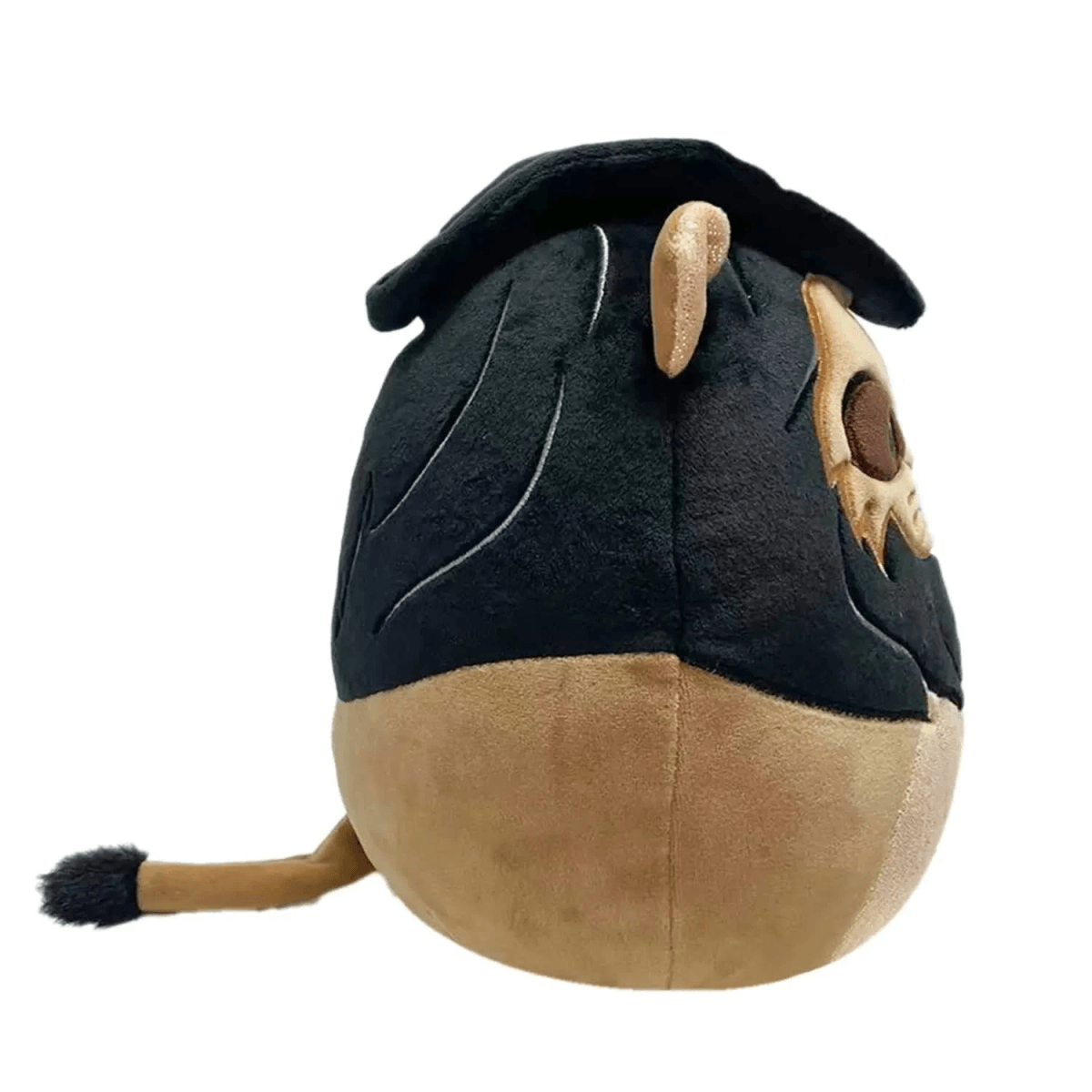Rückansicht eines runden Stofftiers mit schwarzem Oberkörper, brauner Basis und einem Schwanz mit schwarzer Quaste.