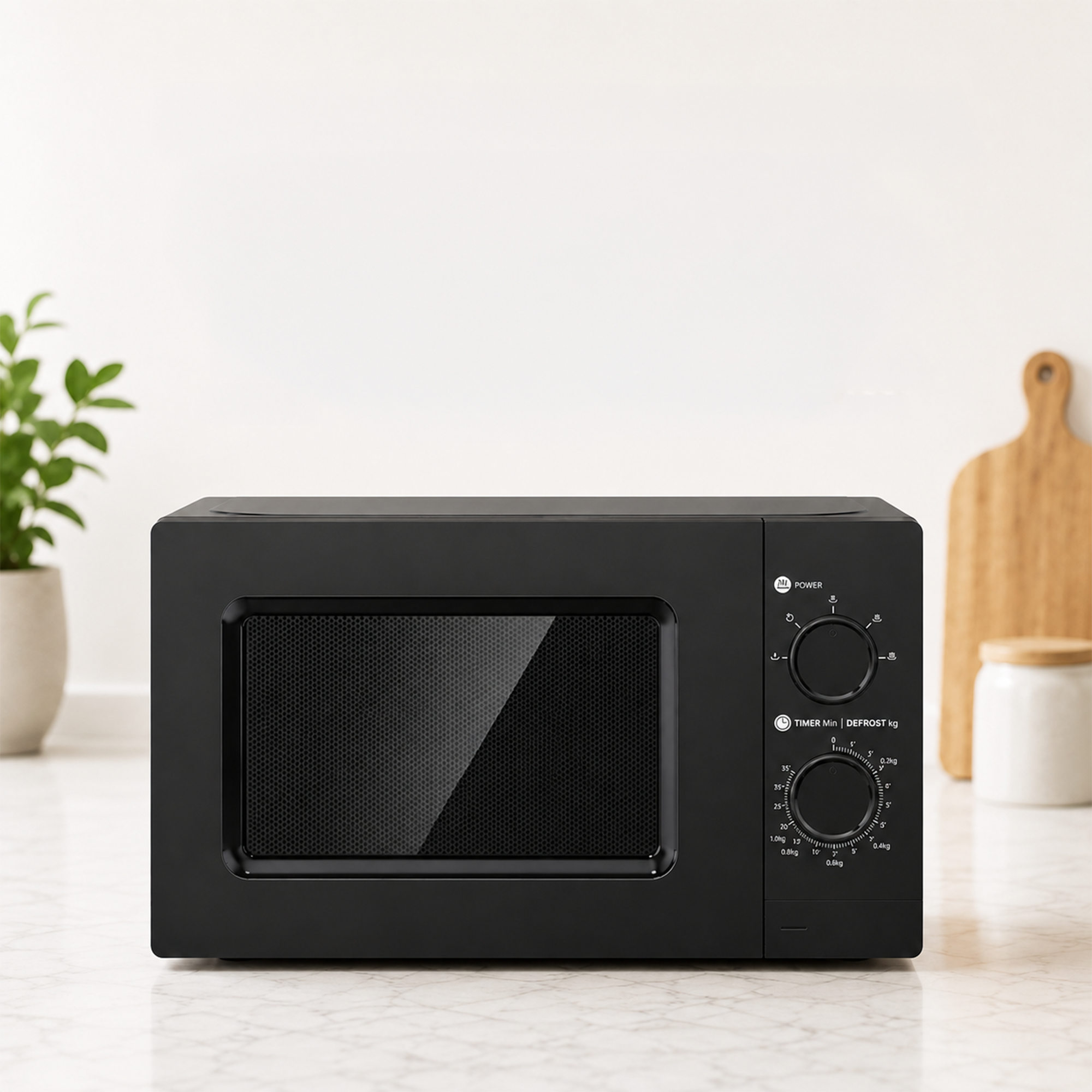 A black microwave on a kitchen countertop with a plant and cutting board in the background.