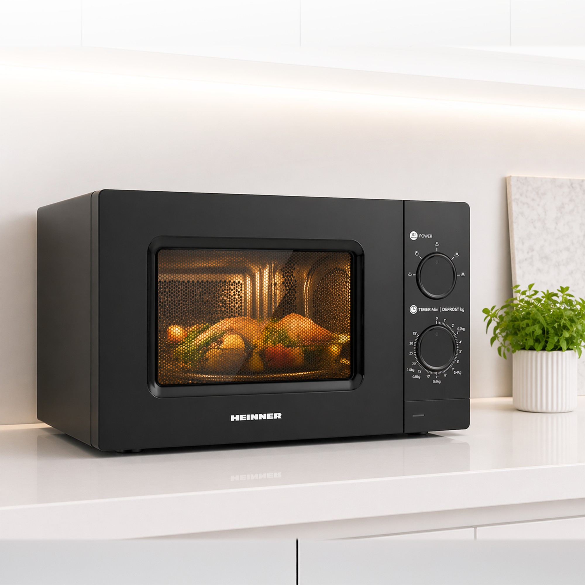 Black Heinner microwave on a white countertop with an illuminated interior showing food.