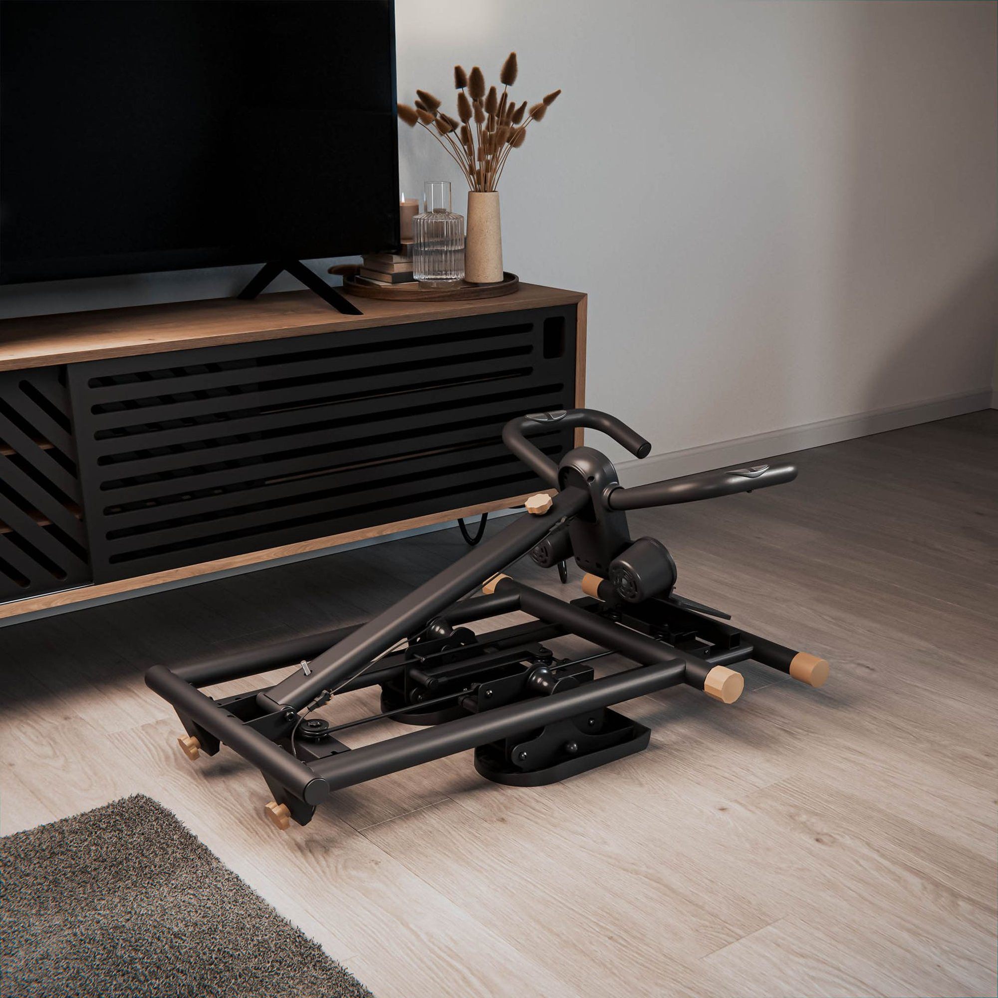 Ein schwarzes Klapp-Fitnessgerät steht auf hellem Holzboden in einem Wohnzimmer neben einem TV-Möbel.