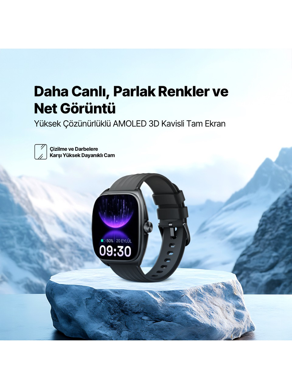 AMOLED ekranlı siyah bir akıllı saat, karlı dağ manzarasının önünde bir kaya üzerinde duruyor.